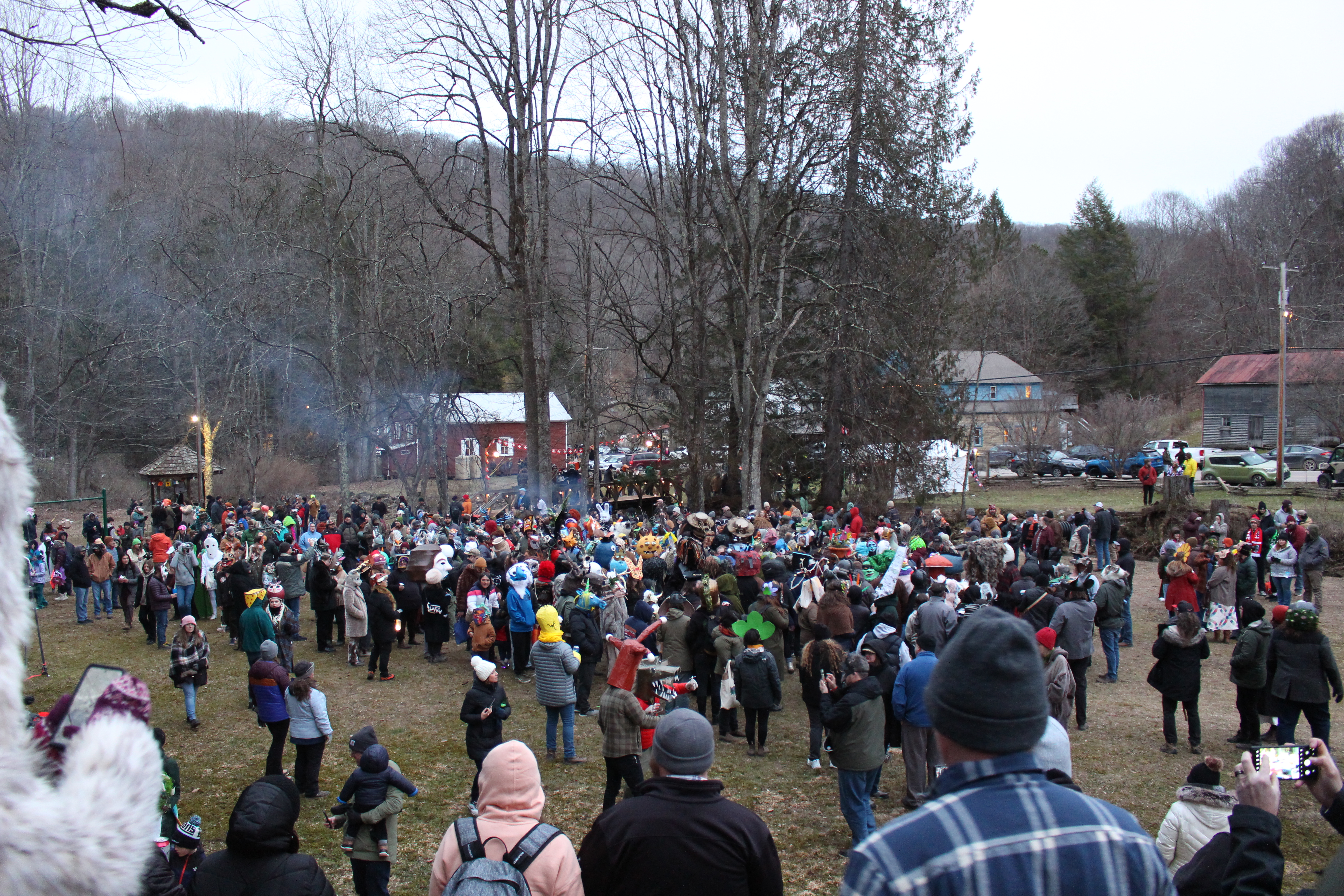 A large crowd of people gather outdoors for the Fasnacht costume contest.